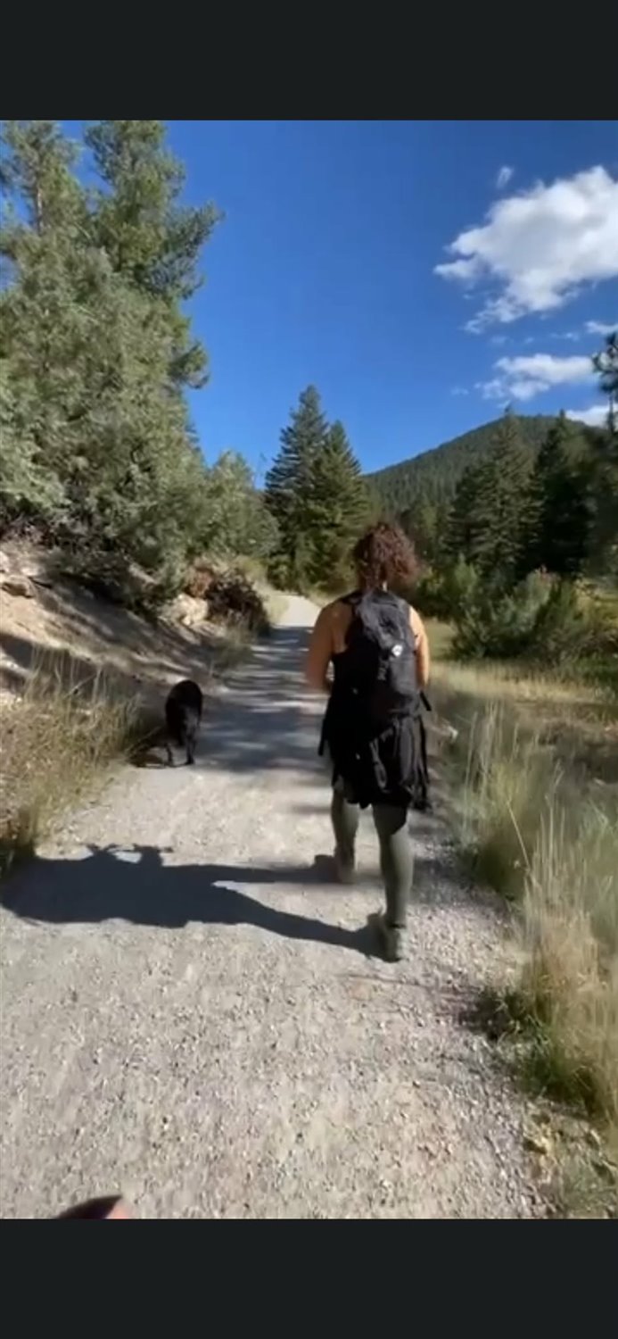 Alani hiking a Montana trail with her dog