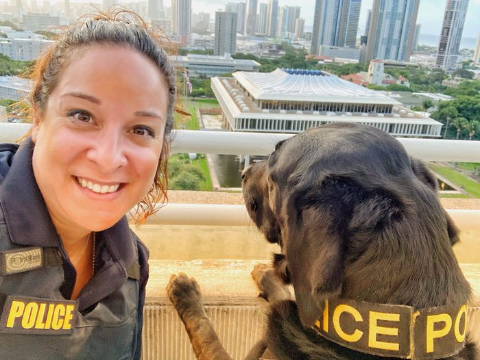 Alani Bankhead in law-enforcement uniform with a working K9.
