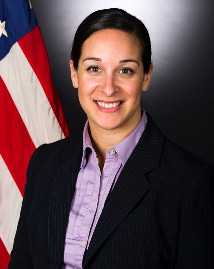 Official portrait of Alani Bankhead as a special agent, in front of the United States flag.